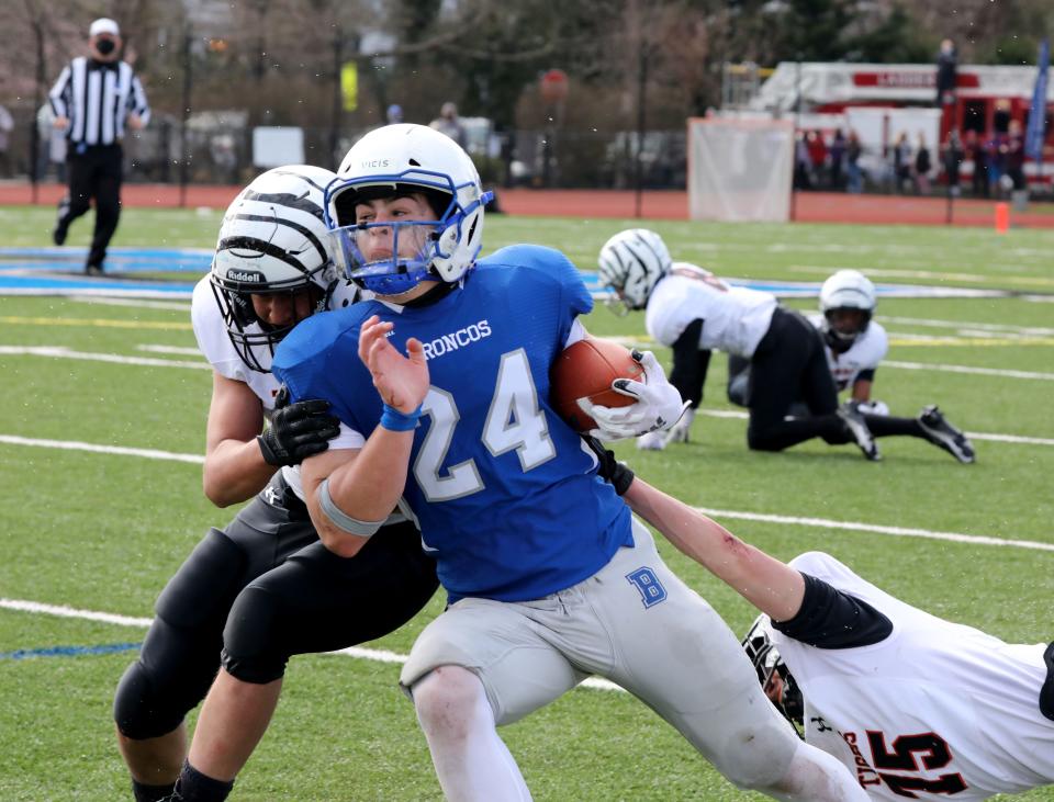 Bronxville's Henry Donohue is pressured by the sidelines during game action at the Bronxville vs. Tuckahoe football game at Bronxville High School, April 1, 2021. Bronxville beat Tuckahoe, 38-0.