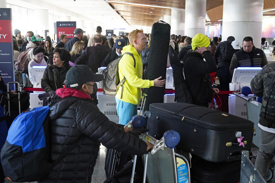 People wait in line to drop off their luggage at Los Angeles International Airport (Jae C. Hong / AP)