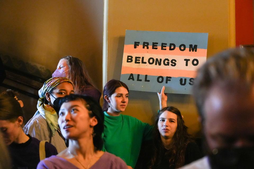 Allyson Swim, left center, and Bee Senior, right center, protest a bill removing gender identity protections from civil rights law on Wednesday, Jan. 31, 2024, at the Iowa State Capitol in Des Moines.