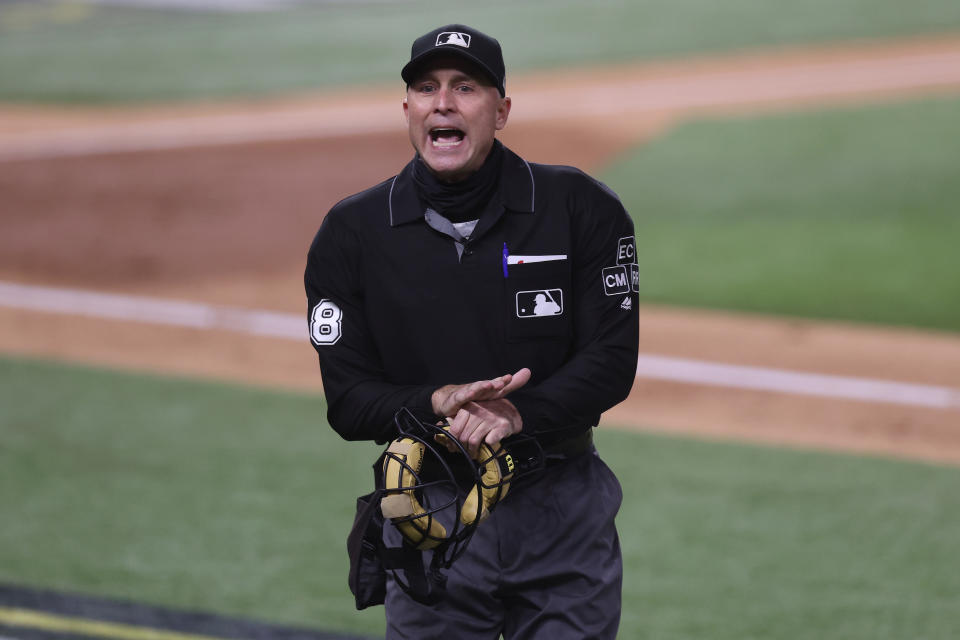 ARLINGTON, TEXAS - OCTOBER 16:  Umpire Dan Iassogna #58 speaks to the Los Angeles Dodgers during the third inning against the Atlanta Braves in Game Five of the National League Championship Series at Globe Life Field on October 16, 2020 in Arlington, Texas. (Photo by Tom Pennington/Getty Images)