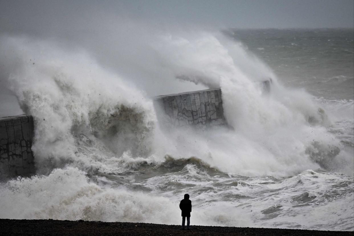 Waves crash the harbour wall in Newhaven, southern England (AFP via Getty Images)