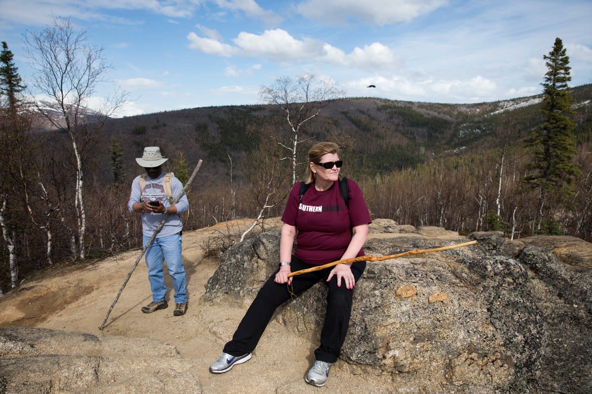 A married couple go hiking in Alaksa.