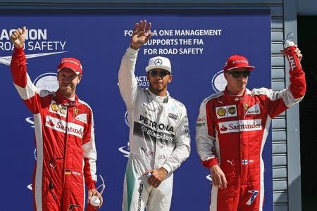 Mercedes Formula One driver Lewis Hamilton (C) of Britain celebrates after getting the pole position at the end of the qualifying session for the Italian F1 Grand Prix in Monza September 5, 2015. REUTERS/Giampiero Sposito