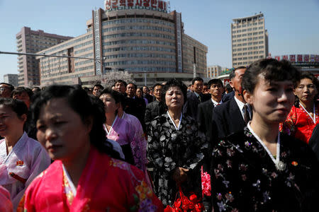 People look towards the stage where North Korean leader Kim Jong Un cut the ribbon during an opening ceremony of a newly constructed residential complex in Ryomyong street in Pyongyang, North Korea April 13, 2017. REUTERS/Damir Sagolj