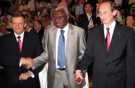 International Association of Athletics Federations (IAAF) President Lamine Diack (C) holds hands with Valentin Balakhnichev (R), President of the All-Russia Athletic Federation, and Valery Vinogradov, Deputy Mayor of Moscow, in Kenya's coastal town of Mombasa March 27, 2007, after Diack announced that Moscow had been selected to host the world athletics championships in 2013. REUTERS/Joseph Okanga