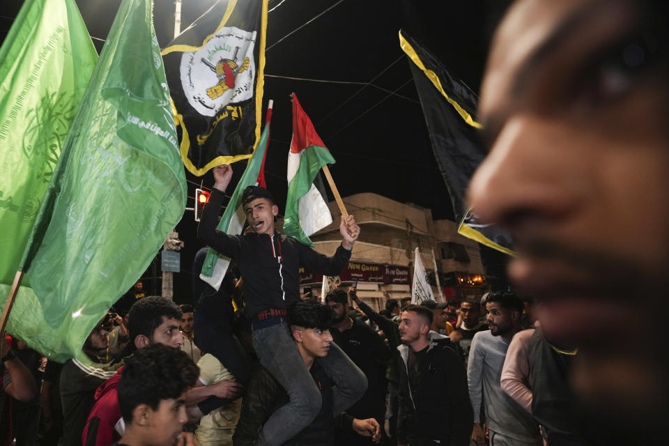 Palestinians celebrate the announcement of a cease-fire after five days of fighting between Israel and the Islamic Jihad militant group in Gaza City, Saturday, May 13, 2023. The two sides agreed to an Egyptian-brokered truce late Saturday, halting fighting that 33 Palestinians, including at least 13 civilians, dead. Two people in Israel were killed by rocket fire. (AP Photo/Adel Hana)