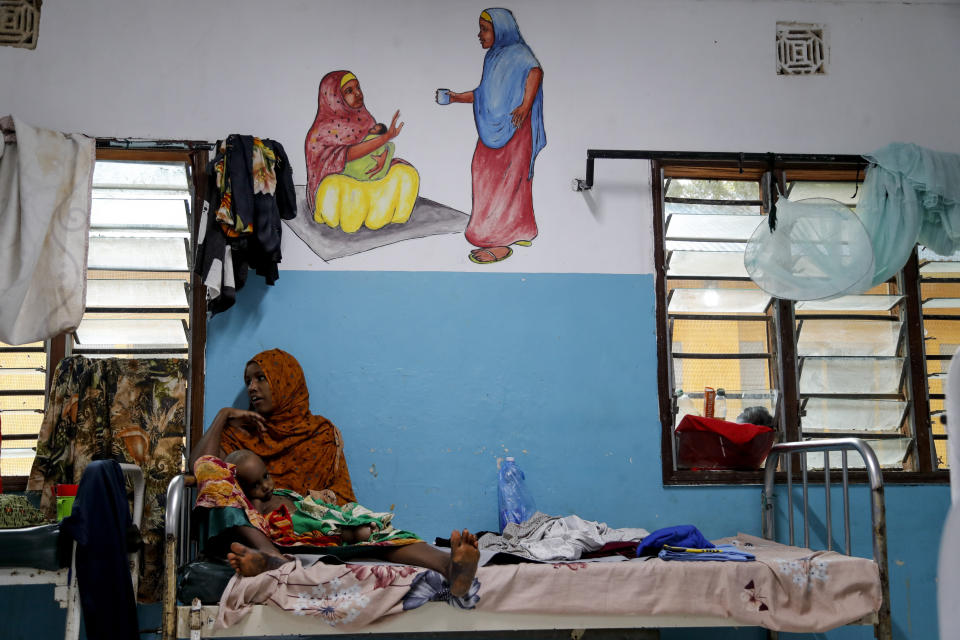 A mother sits with her malnourished child inside the International Rescue Committee (IRC) hospital at Dadaab refugee camp in northern Kenya Wednesday, July 12, 2023. One of the world's largest refugee camps offers a stark example of the global food security crisis with thousands of people fleeing Somalia in recent months to escape drought and extremism but finding little to eat when they arrive at the Dadaab camp in neighboring Kenya. (AP Photo/Brian Inganga)