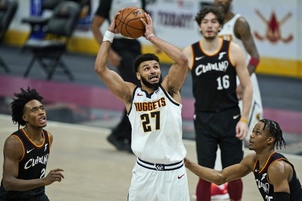 Denver Nuggets' Jamal Murray (27) shoots against the Cleveland Cavaliers during the second half of an NBA basketball game, Friday, Feb. 19, 2021, in Cleveland. (AP Photo/Tony Dejak)