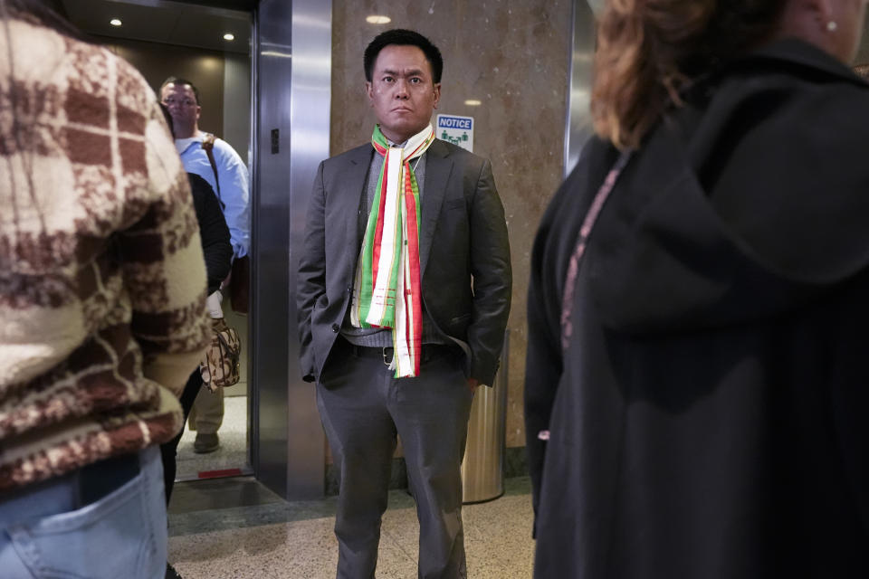 Pau Hau from Burma of the Tennessee Immigrant and Refugee Rights Coalition waits for an elevator at the state legislative offices, Tuesday, March 19, 2024, in Nashville, Tenn. Members of the group came to the state Capitol to lobby legislators to vote against legislation that require local law-enforcement agencies to operate as if they have federal 287(g) agreements and a bill criminalizing transportation of undocumented immigrants. (AP Photo/George Walker IV)