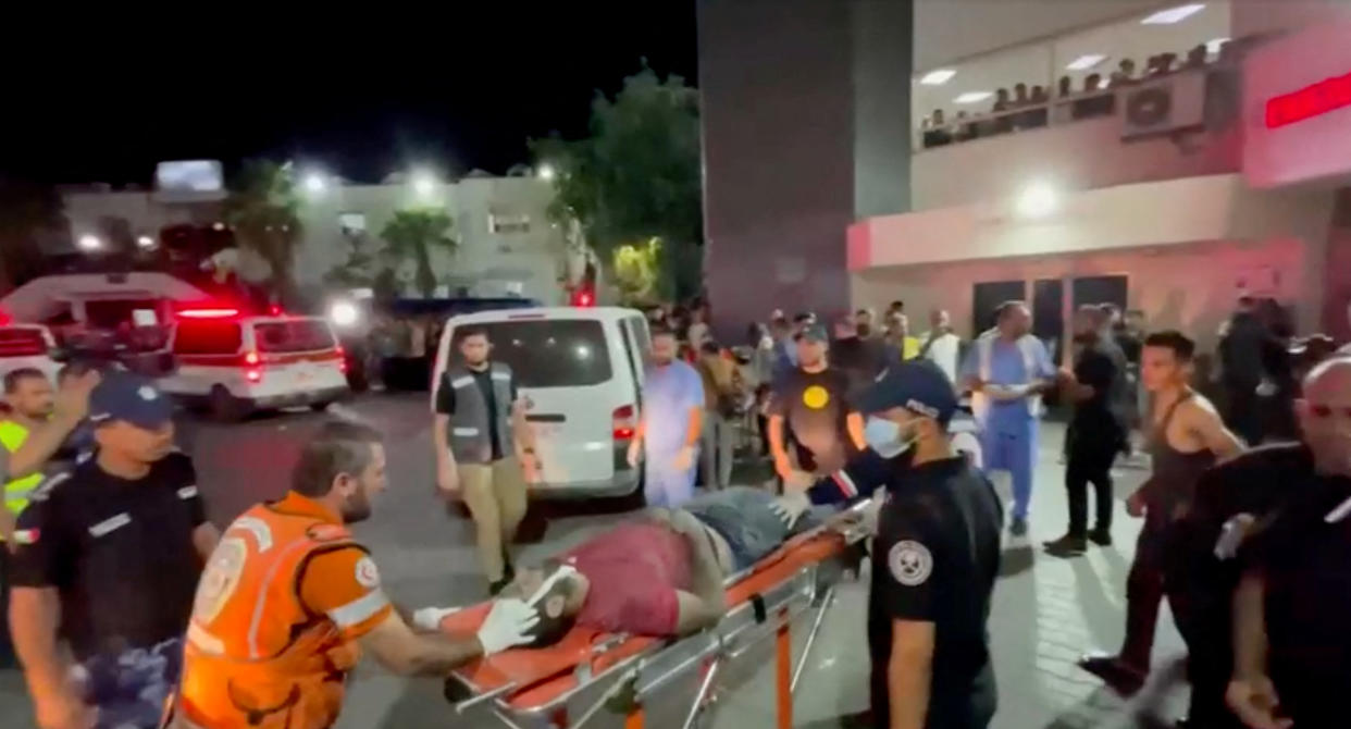 An injured person is taken into a hospital after Israeli air strike hit a hospital, according to Hamas Health Ministry, in Gaza City, Gaza Strip, in this screen grab obtained from video, October 17, 2023.  REUTERS/Reuters TV