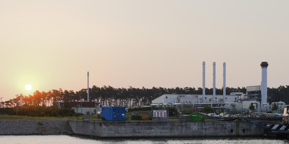 FILE - The sun rises behind the landfall facility of the Nord Stream 1 Baltic Sea pipeline and the transfer station of the OPAL gas pipeline, the Baltic Sea Pipeline Link, in Lubmin, Germany, Thursday, July 21, 2022. The suspected sabotage this week of two gas pipelines that tied Russia and Europe together is driving home how vital yet weakly protected undersea infrastructure is vulnerable to attack, with potentially catastrophic repercussions for the global economy. (AP Photo/Markus Schreiber, File)