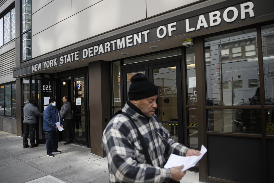 FILE - In this March 18, 2020 file photo, visitors to the Department of Labor are turned away at the door by personnel due to closures over coronavirus concerns in New York. A record-high number of people applied for unemployment benefits last week as layoffs engulfed the United States in the face of a near-total economic shutdown caused by the coronavirus. The surge in weekly applications for benefits far exceeded the previous record set in 1982. (AP Photo/John Minchillo, File)