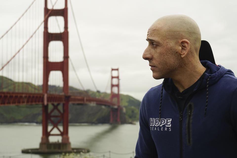 In this photo provided by Kevin Hines, he is seen looking towards the Golden Gate Bridge in San Francisco in May of 2019. Hines miraculously survived his suicide attempt from the bridge at age 19 in September 2000 as he struggled with bipolar disorder. A suicide prevention barrier at San Francisco's Golden Gate Bridge has been completed more than a decade after officials approved it. (Kevin Hines via AP)