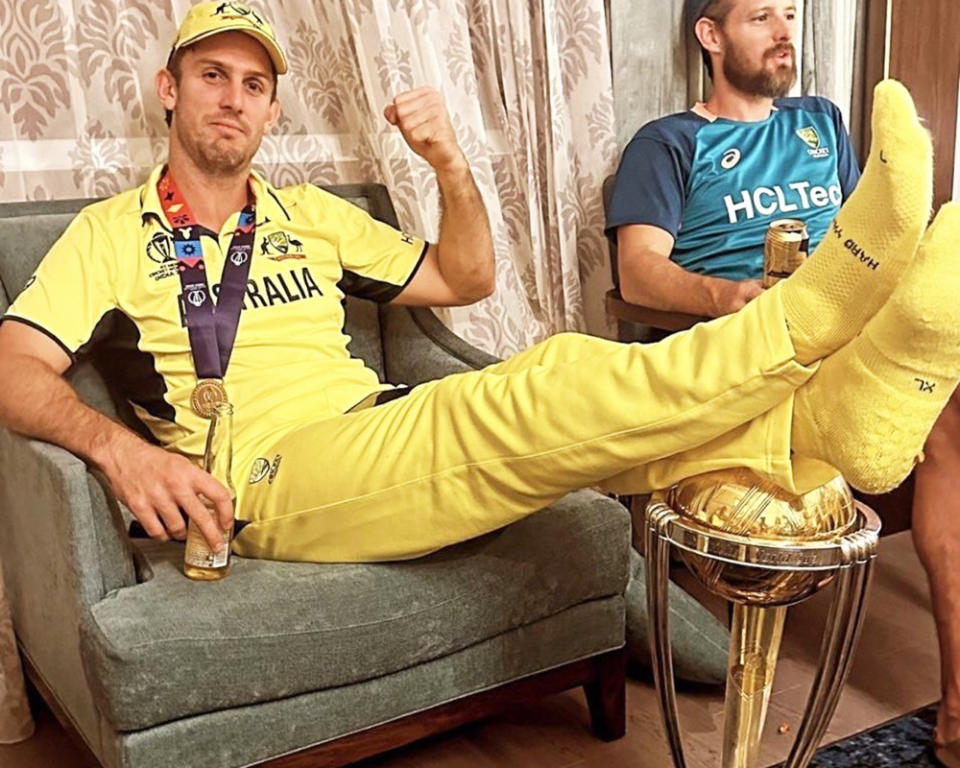 Mitch Marsh, pictured here with his feet on the Cricket World Cup trophy.