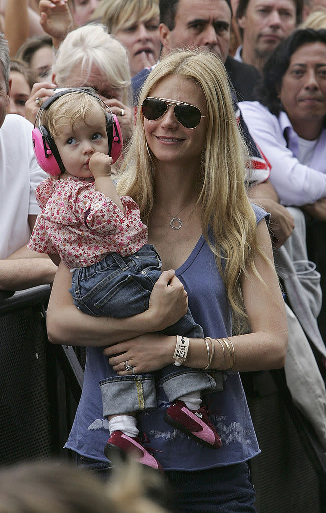 Gwyneth Paltrow holds daughter Apple during Coldplay's performance at 