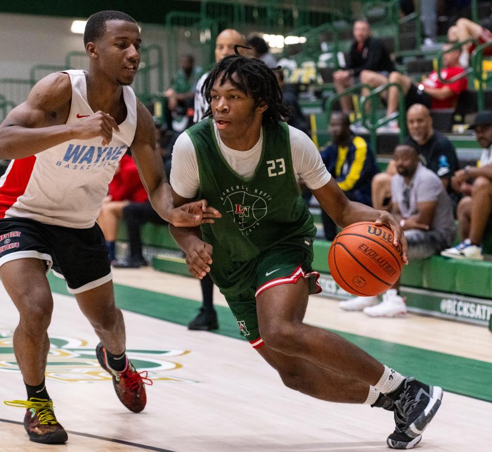 Lawrence North High School's Azavier Robinson (23) drives the ball along the baseline during Charlie Hughes Shootout basketball action, Saturday, June 24, 2023, at Westfield High School.