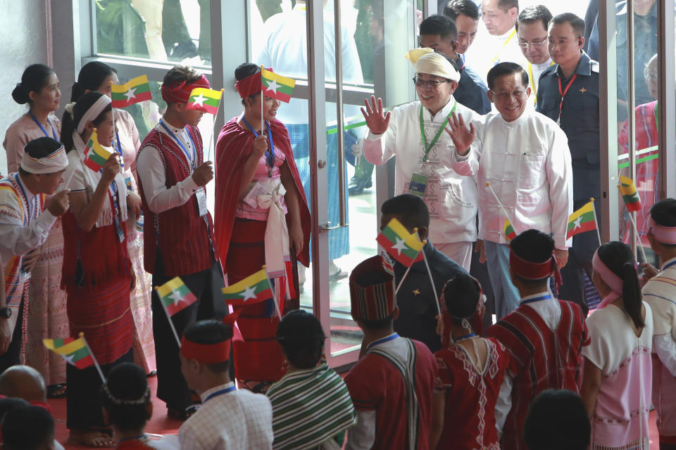 Senior Gen. Min Aung Hlaing, head of the military council, center right, and Restoration Council of Shan State-RCSS (SSA) Chairman Sao Yawd Serk, center left, arrives to attend the 8th anniversary of the Nationwide Ceasefire Agreement (NCA) at the Myanmar International Convention Center in Naypyitaw, Myanmar, Sunday, Oct. 15, 2023. (AP Photo/Aung Shine Oo)