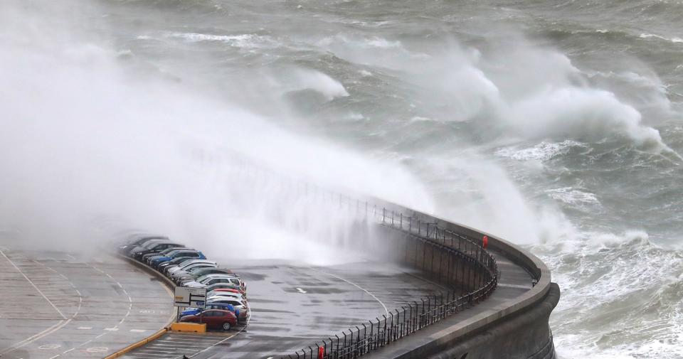 Waves crash onto cars on the harbour arm at the Port of Dover in Kent during Storm Gareth in March (PA)