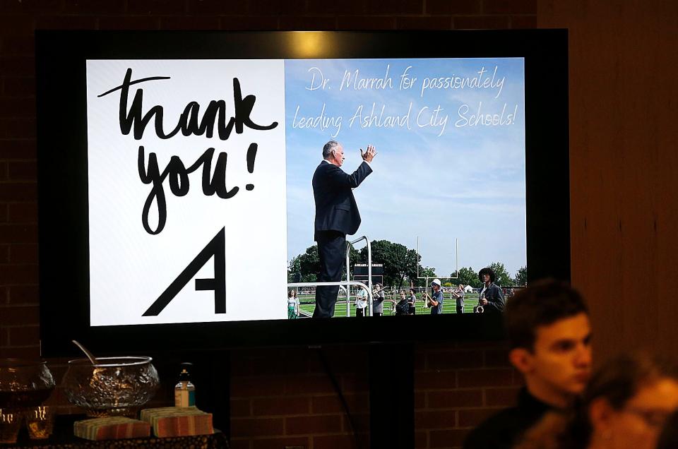 A video shows on a TV screen during the reception at Ashland High School for Superintendent Doug Marrah's retirement on Monday, Dec. 12, 2022. TOM E. PUSKAR/ASHLAND TIMES-GAZETTE