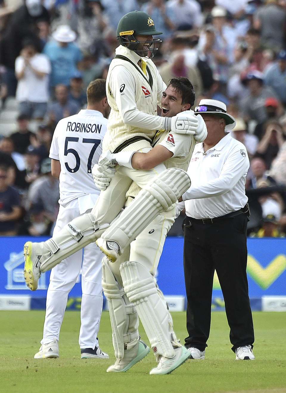 Australia captain Pat Cummins, right, celebrates with Australia's Nathan Lyon after beating England during day five of the first Ashes Test cricket match, at Edgbaston, Birmingham, England, Tuesday, June 20 2023. (AP Photo/Rui Vieira)