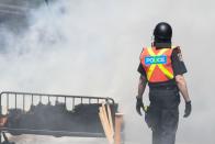 <p>Police walk past furniture set on fire by protesters during a demonstration in Quebec City on June 8, 2018, as the G7 Summits gets underway. (Photo: Martin Ouellet-Diotte/AFP/Getty Images) </p>