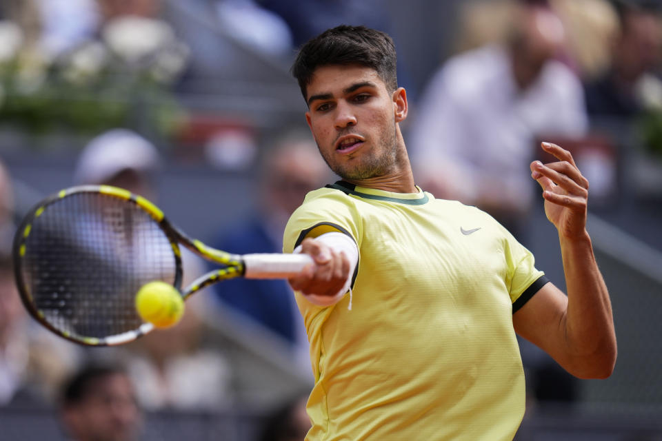 Carlos Alcaraz, of Spain, returns the ball to Alexander Shevchenko, of Kazakhstan, during the Mutua Madrid Open tennis tournament in Madrid, Friday, April 26, 2024. (AP Photo/Manu Fernandez)