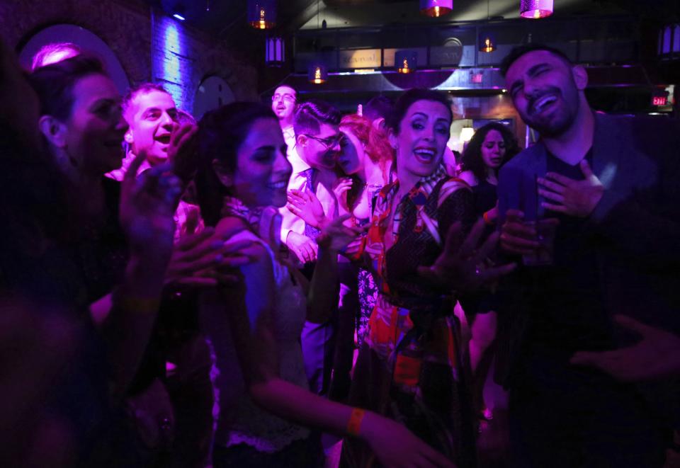 In this Sunday, April 14, 2019 photo, volunteers enjoy dancing during the Tirgan Volunteers Appreciation Party in Toronto, Canada. Tirgan Festival benefits the support of over 400 young volunteers. The event aims to preserve and celebrate Iranian and Persian culture, said festival CEO Mehrdad Ariannejad. Among those who attended were second-and third-generation immigrants, many of whom have never been to Iran or have not been there since leaving the country following the 1979 Islamic Revolution. (AP Photo/Kamran Jebreili)