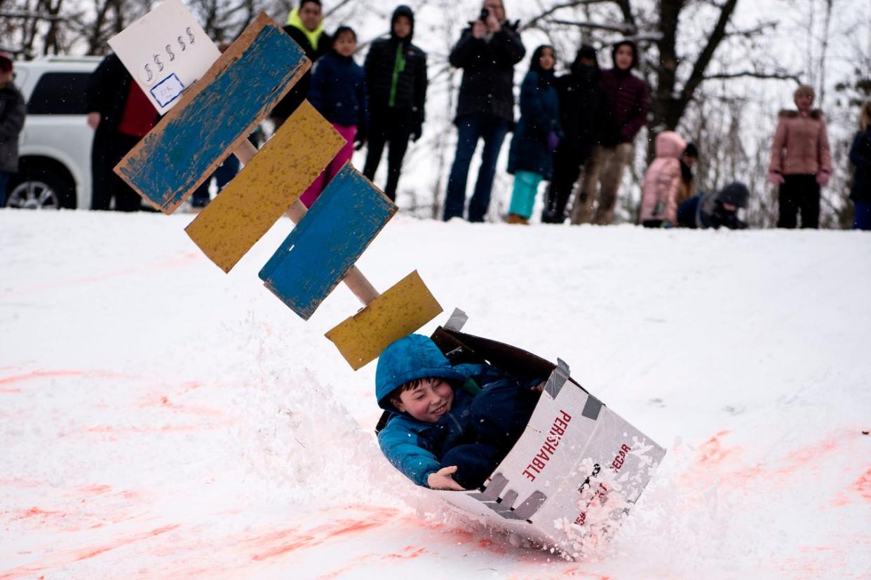 Ethan Dickert, 9, crashes during the Festivus 2020 Cardboard Sled Competition at Leila Arboretum in Battle Creek.