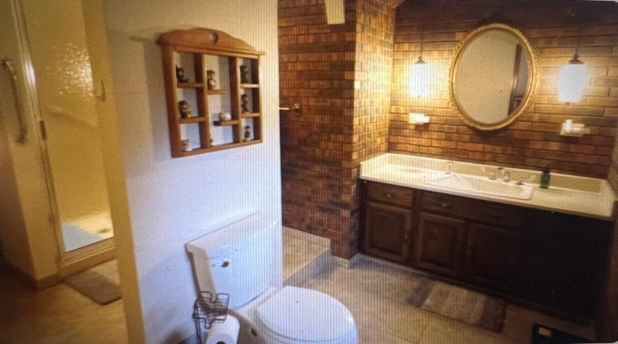 This castle-like home in Hartford, Wis., features a bathroom with a toilet in the middle of the room.