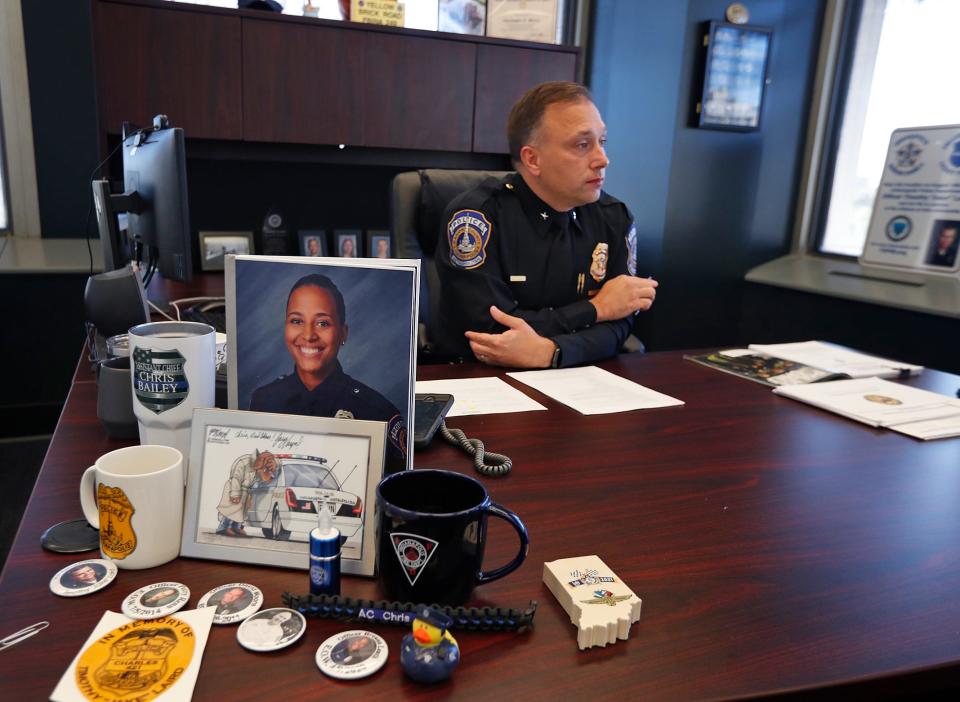 IMPD Assistant Chief Chris Bailey talks about the local homicide rate, during an interview Wednesday, Oct. 27, 2021 in his City-County Building office. Photos and other mementos about officers who have died in the line of duty sit on his desk.