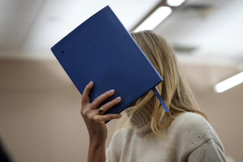 FILE - Actor Gwyneth Paltrow shields her face with a blue notebook as she exits a courtroom on March 21, 2023, in Park City, Utah. Paltrow's live-streamed trial over a 2016 collision at a posh Utah ski resort has drawn worldwide attention, spawning memes and sparking debate about the burden and power of celebrity. (AP Photo/Rick Bowmer, Pool, File)