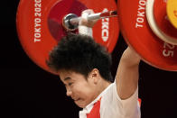Hou Zhihui of China competes in the women's 49kg weightlifting event, at the 2020 Summer Olympics, Saturday, July 24, 2021, in Tokyo, Japan. She won the gold medal and sets Olympic record. (AP Photo/Luca Bruno)