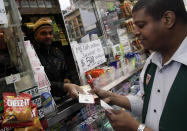 Mega Millions lottery contestant Hector Caminero buys $215 worth of tickets for Friday's $500-million game at a corner newsstand in New York, Thursday, March 29, 2012. Forget setting up a charity or establishing a trust, the winner of the $500 million Mega Millions jackpot could save teachers' jobs or help pay for Medicaid-funded doctor appointments in their home state just by paying taxes. (AP Photo/Richard Drew)