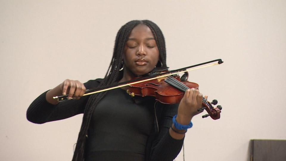 A community members plays a violin performance of Bob Marley and The Wailers' One Love for the Black Impact Alliance Foundation of Beaumont's inaugural Black History Month event.