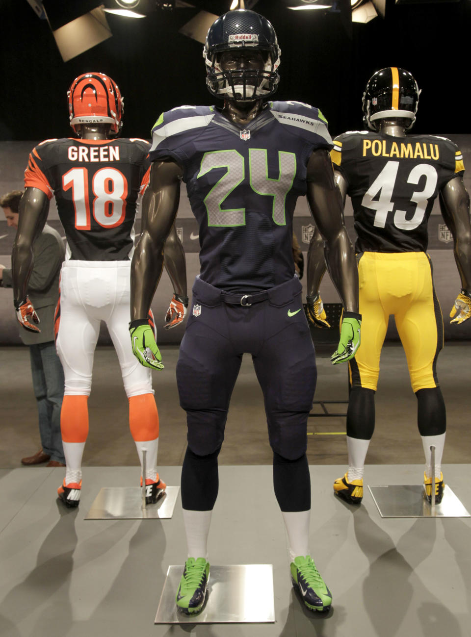 The new Seattle Seahawks uniform, foreground, Pittsburgh Steelers, rear right, and Cincinnati Bengals, rear left, are displayed on mannequins during a presentation in New York, Tuesday, April 3, 2012. The NFL and Nike showed off the new gear in grand style with a gridiron-themed fashion show at a Brooklyn film studio. (AP Photo/Seth Wenig)
