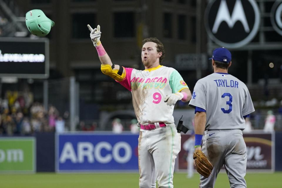 San Diego's Jake Cronenworth tosses his batting helmet.