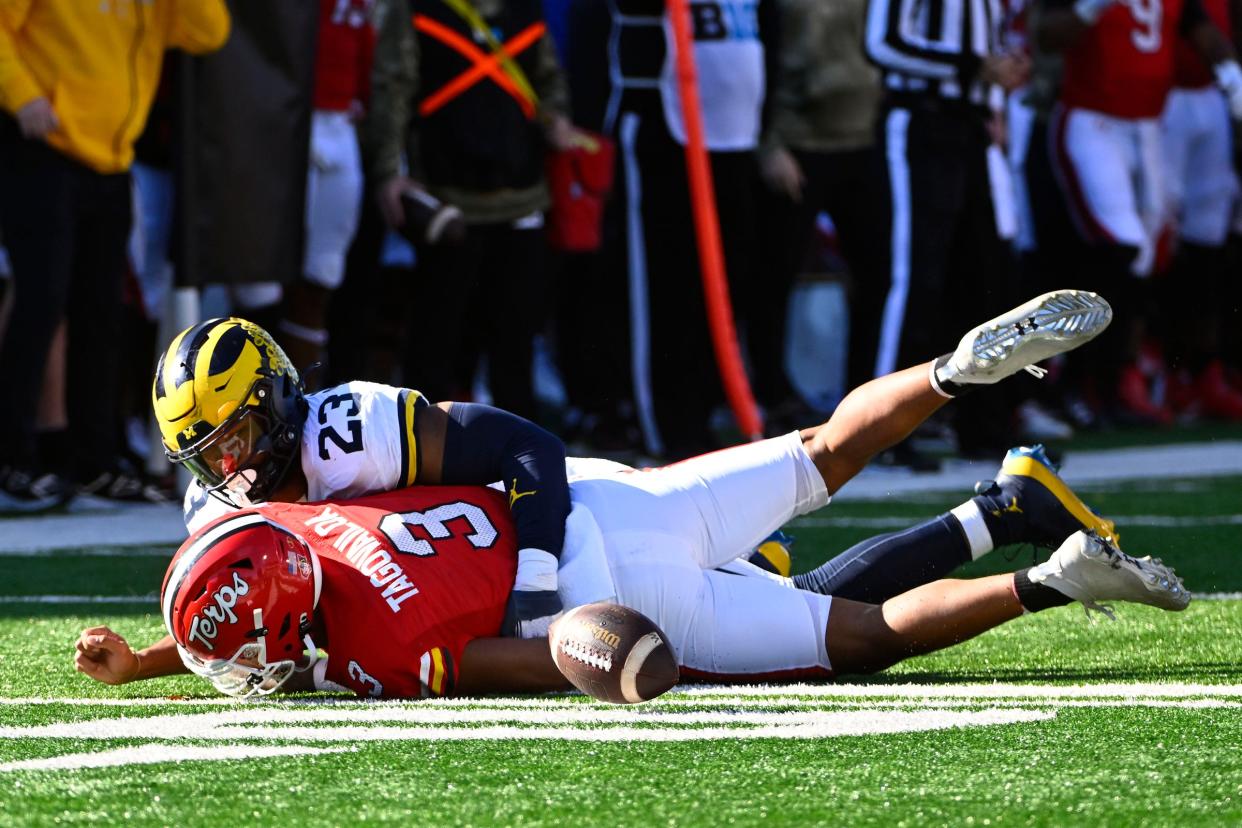 Michigan Wolverines linebacker Michael Barrett sacks Maryland Terrapins quarterback Taulia Tagovailoa causing a fumble during the first half at SECU Stadium in College Park, Maryland, Nov. 18, 2023.