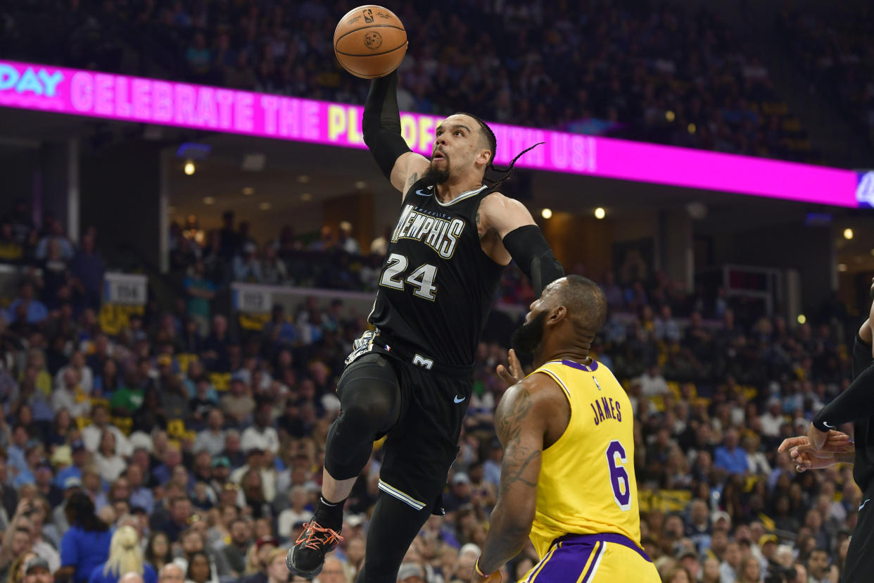 Memphis Grizzlies forward Dillon Brooks (24) goes sup for a dunk against Los Angeles Lakers forward LeBron James (6) during the first half of Game 2 of a first-round NBA basketball playoff series Wednesday, April 19, 2023, in Memphis, Tenn. (AP Photo/Brandon Dill)