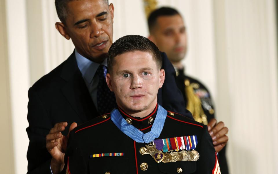 Obama presents the Medal of Honor to retired U.S. Marine Corps Corporal Carpenter during a ceremony at the White House in Washington