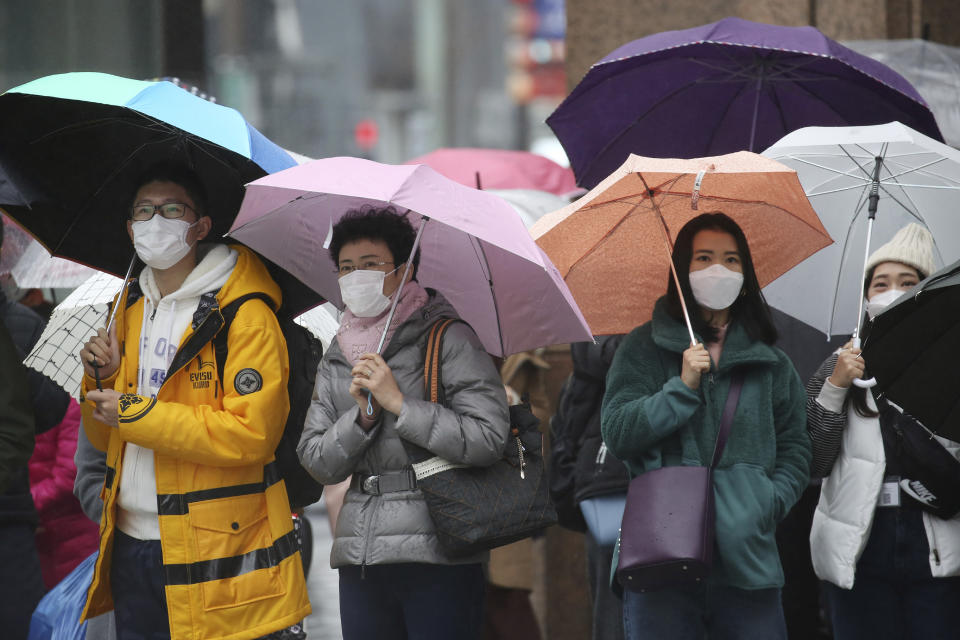 People wear masks at Ginza shopping district in Tokyo, Tuesday, Jan. 28, 2020. China has confirmed more than 4,500 cases of a new virus. Most have been in the central city of Wuhan where the outbreak began in December. More than 45 cases have been confirmed in other places with nearly all of them involving Chinese tourists or people who visited Wuhan recently. (AP Photo/Koji Sasahara)