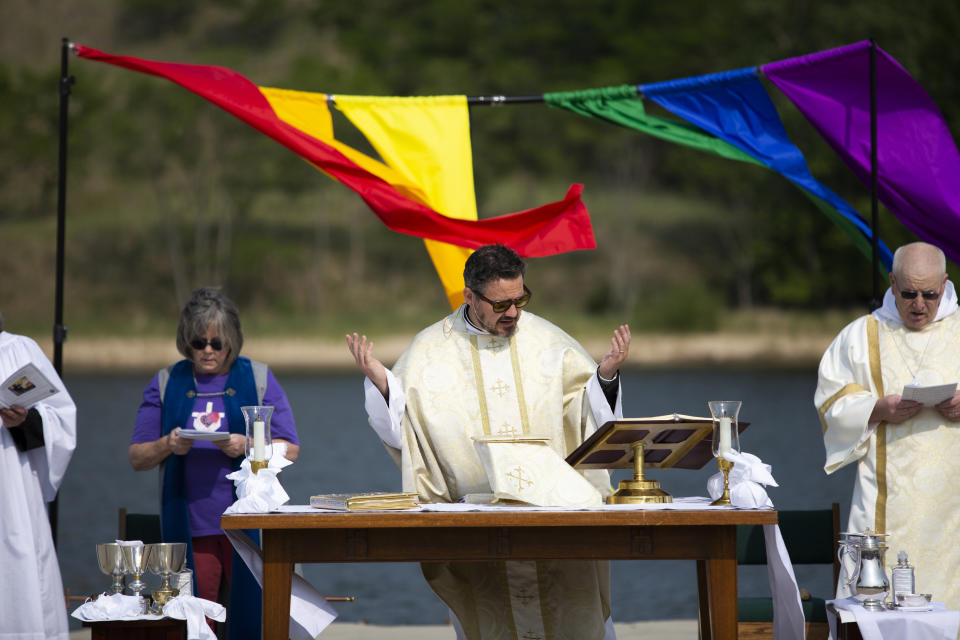 Rev. Dr. Jared Cramer of St. John's Episcopal Church and clergy members are seen during a pride worship service at the Lynne Sherwood Waterfront Stadium in Grand Haven, Mich., on Saturday, June 10, 2023. The festival — which organizers had hoped would attract at least 500 attendees — drew thousands of people from all over who came to experience the first-time event's drag show, dance party and vendor-filled streets. (AP Photo/Kristen Norman)