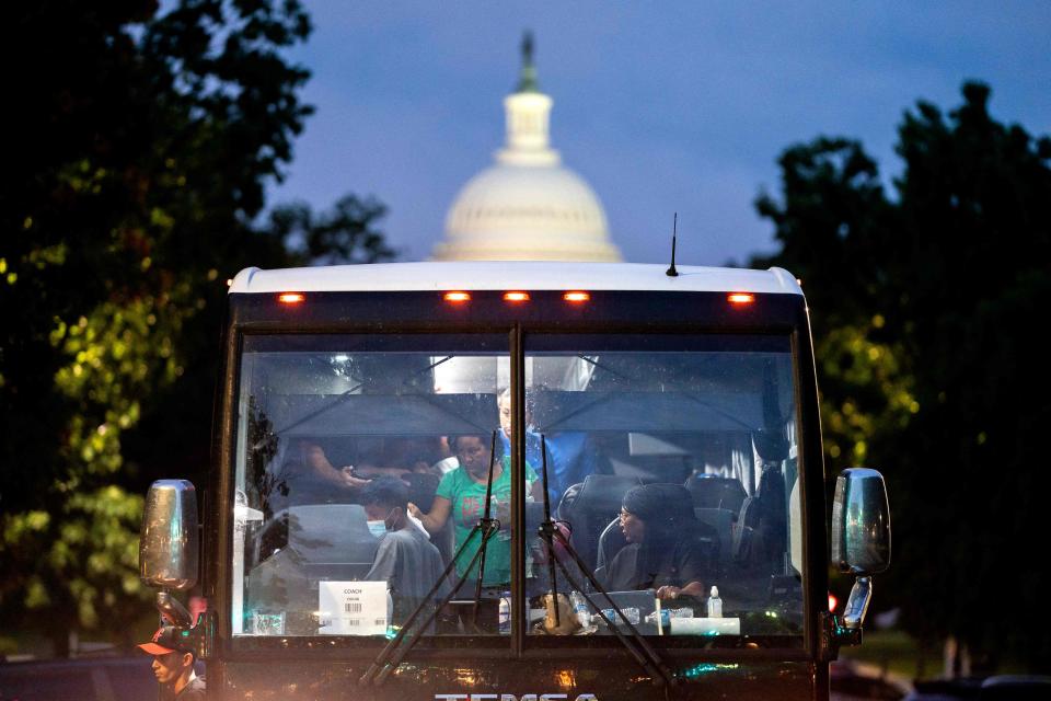 Migrants, who boarded a bus in Texas, are dropped off within view of the U.S. Capitol building in Washington, D.C., on Aug. 11, 2022. - Since April, Texas Gov. Greg Abbott has ordered buses to carry thousands of migrants from Texas to Washington, D.C., and New York City to highlight criticisms of President Joe Biden's border policy.