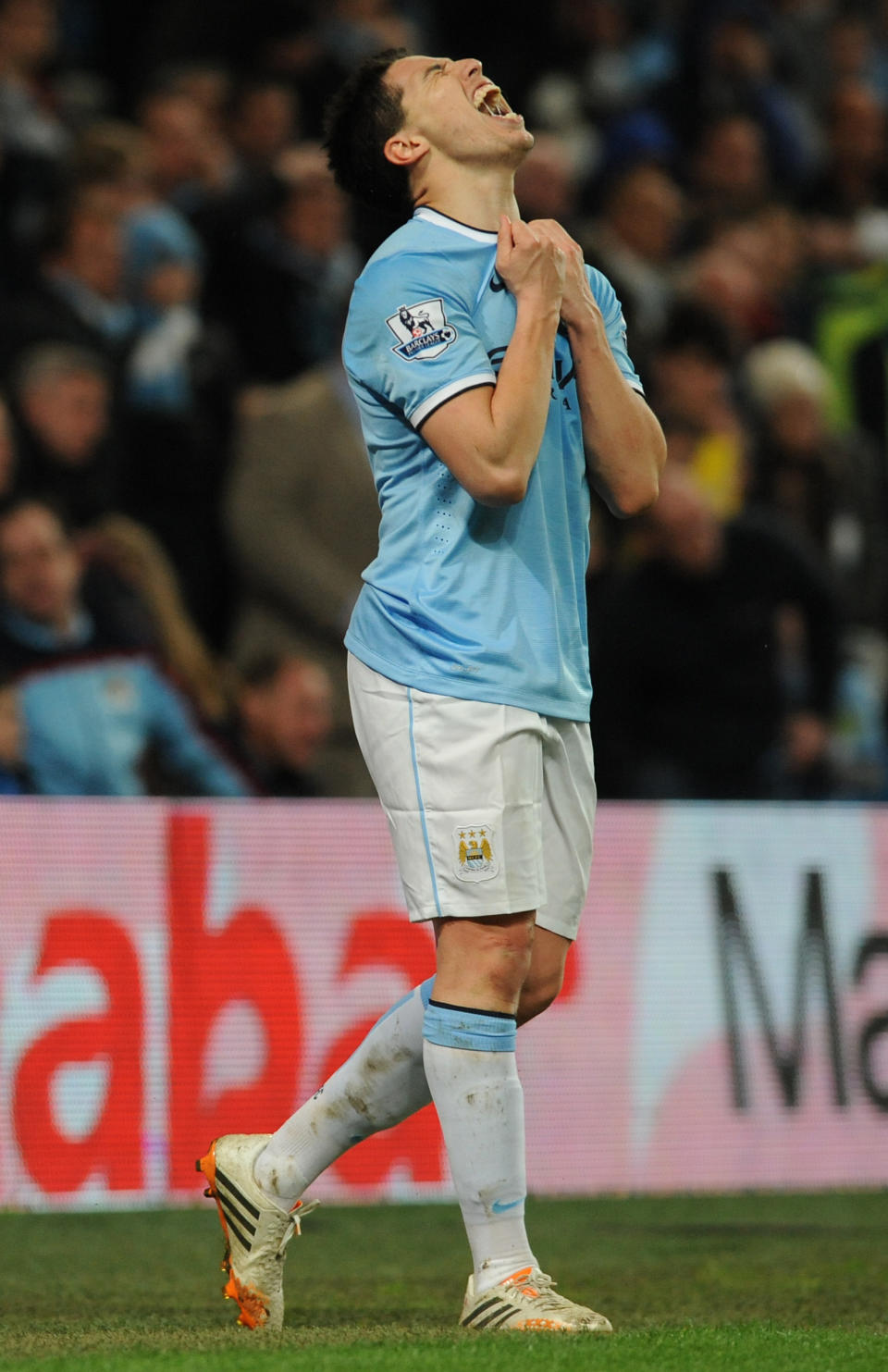 Manchester City's Samir Nasri grimaces after missing a goal scoring opportunity during the English Premier League soccer match between Manchester City and Sunderland at The Etihad Stadium, Manchester, England, Wednesday, April 16, 2014. (AP Photo/Rui Vieira)