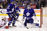 Toronto Maple Leafs goaltender Frederik Andersen (31) looks back at his net after Carolina Hurricanes center Martin Necas (not shown) scored during third-period NHL hockey game action in Toronto, Saturday, Feb. 22, 2020. Hurricanes left wing Erik Haula (56) and Maple Leafs center Alexander Kerfoot (15) look on. (Frank Gunn/The Canadian Press via AP)