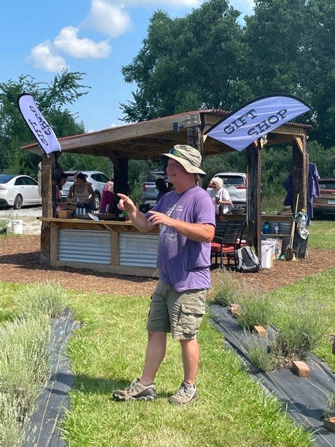 Lavender farm owner Jim Duxburt speaks with the group during the visit.