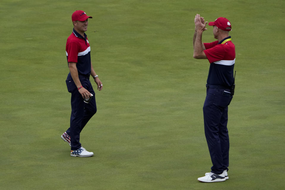 Team USA assistant captain Jim Furyk applauds Justin Thomas after the Ryder Cup matches at the Whistling Straits Golf Course Sunday, Sept. 26, 2021, in Sheboygan, Wis. (AP Photo/Jeff Roberson)