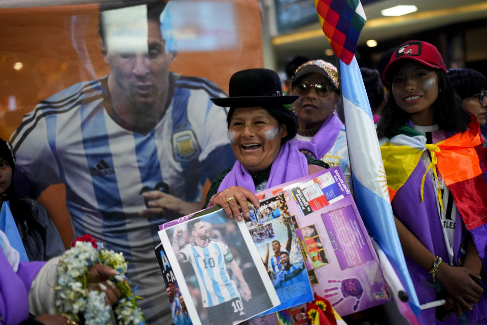 A woman holds a picture of Argentina's soccer star Lionel Messi as she waits for the arrival of the Argentina national soccer team, at the airport in El Alto, Bolivia, Sunday, Sept. 10, 2023. Argentina will face Bolivia for a qualifying soccer match for the FIFA World Cup 2026. (AP Photo/Juan Karita)