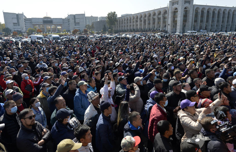 People protest during a rally on the central square in Bishkek, Kyrgyzstan, Wednesday, Oct. 7, 2020. Officials in Kyrgyzstan have nullified the results of a weekend parliamentary election after mass protests erupted in the capital of Bishkek and other cities, with opposition supporters seizing government buildings and demanding a new vote. (AP Photo/Vladimir Voronin)