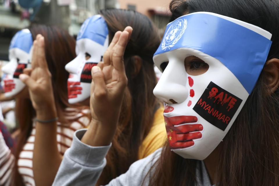 Young demonstrators flash the three-fingered symbol of resistance during an anti-coup mask strike in Yangon, Myanmar, Sunday, April 4, 2021. Threats of lethal violence and arrests of protesters have failed to suppress daily demonstrations across Myanmar demanding the military step down and reinstate the democratically elected government. (AP Photo)