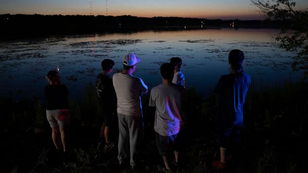 PHOTO: Friends and family gathered at Vadnais Lake after news of a dead child being pulled out of the lake broke, July 1, 2022 in Vadnais Heights, Minn. (Alex Kormann/Star Tribune via AP)